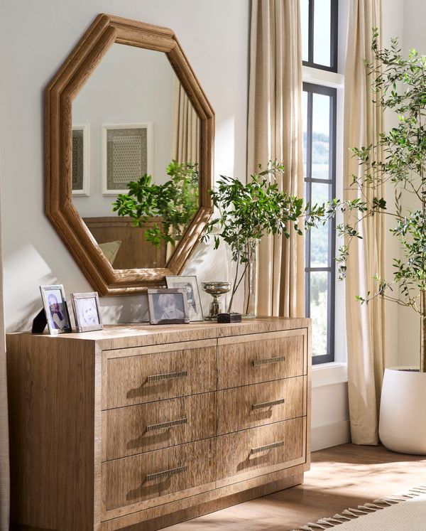 Oak dresser under an octagonal wood mirror